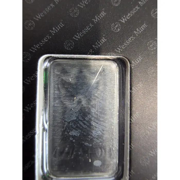 1g 999 silver - milk spotting and fingerprint present